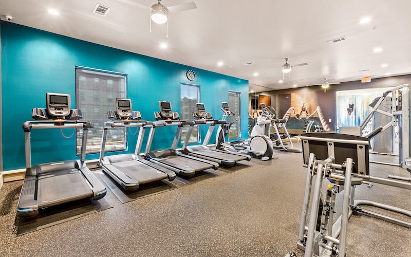 Large fitness center with large windows and plenty of equipment